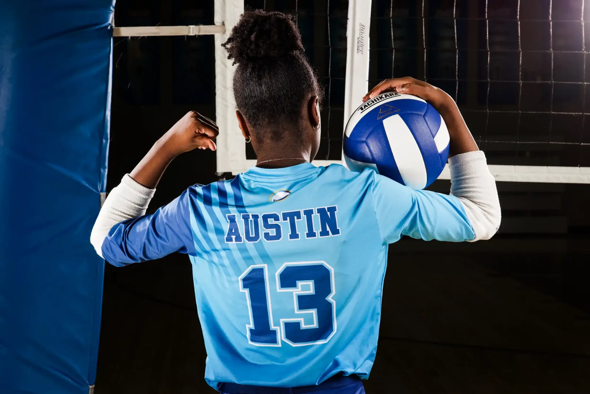 Inspire CLE Volleyball player at the net holding a volleyball