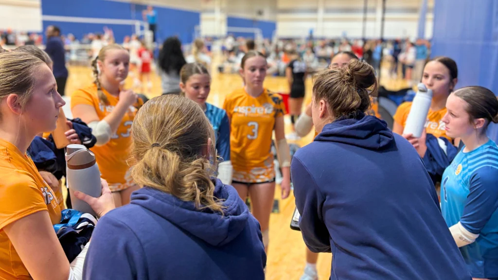 Inspire CLE Volleyball coaches huddle with the team between sets